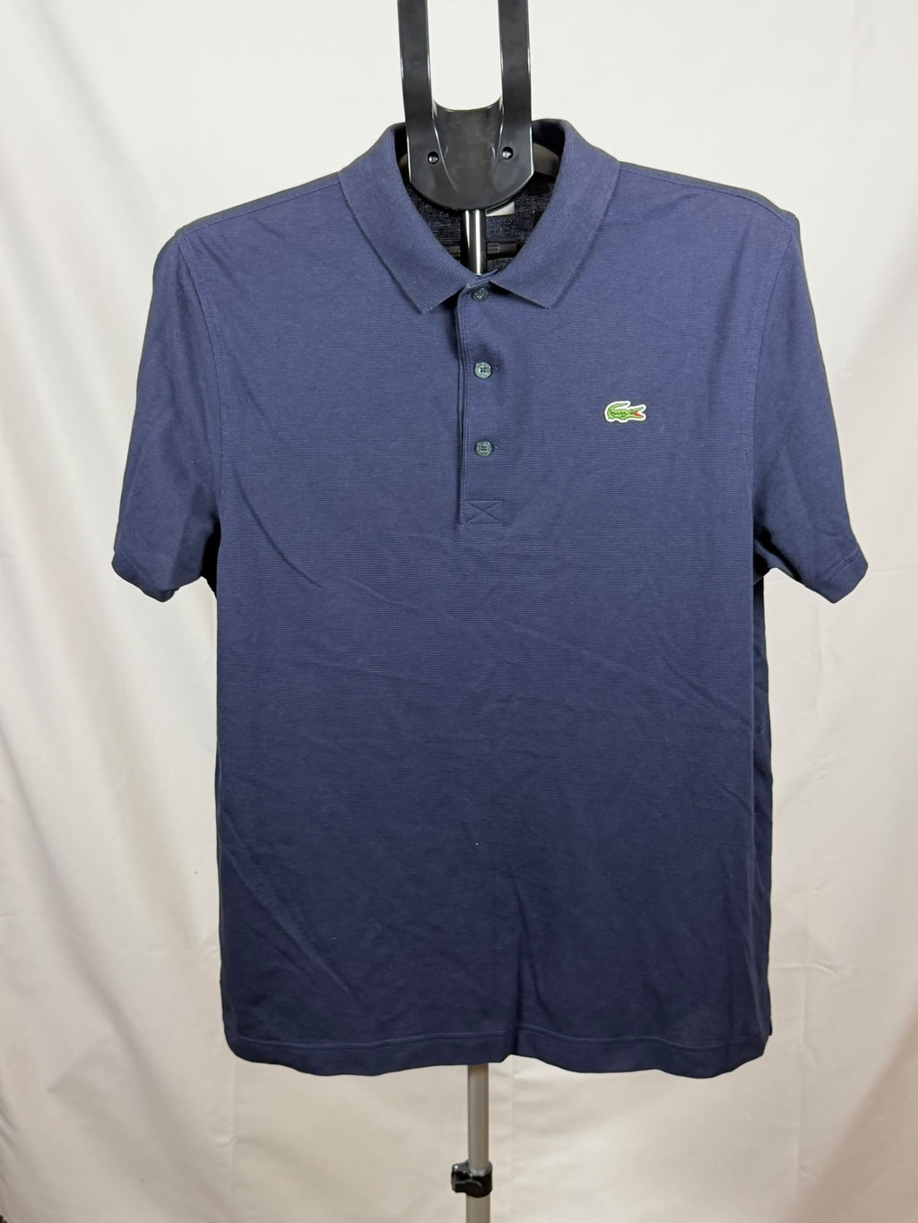 blue Lacoste short-sleeve polo shirt featuring a classic collar (L)